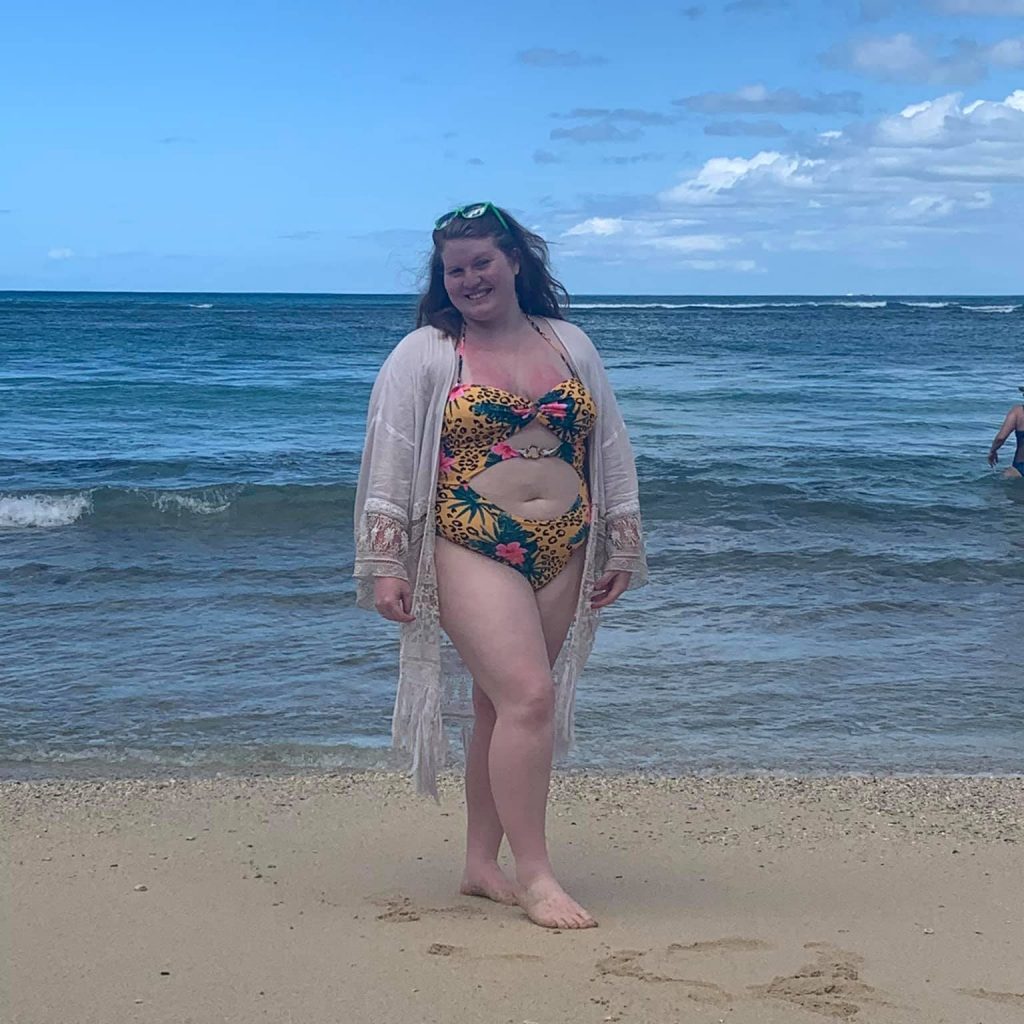 Posing in my swimsuit in front of Queens's Beach