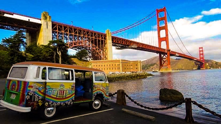 Volkswagen van in front of Golden Gate Bridge