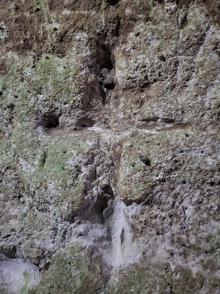 Carved cross in the wall