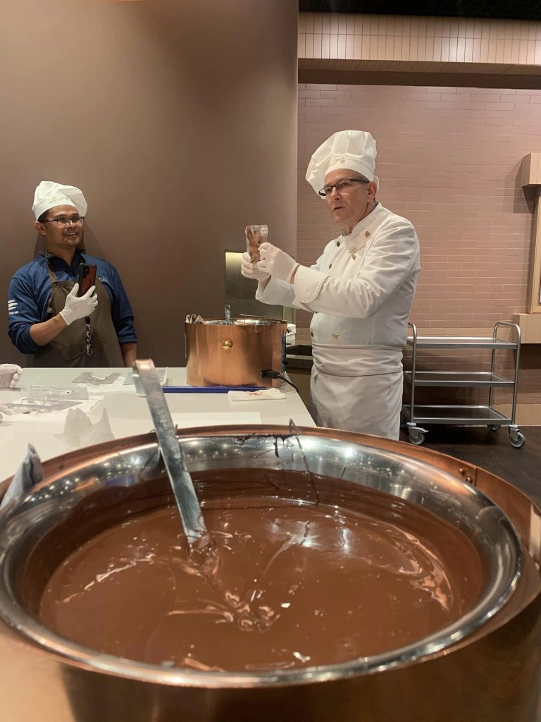 Our instructor teaching us how to mold the chocolate